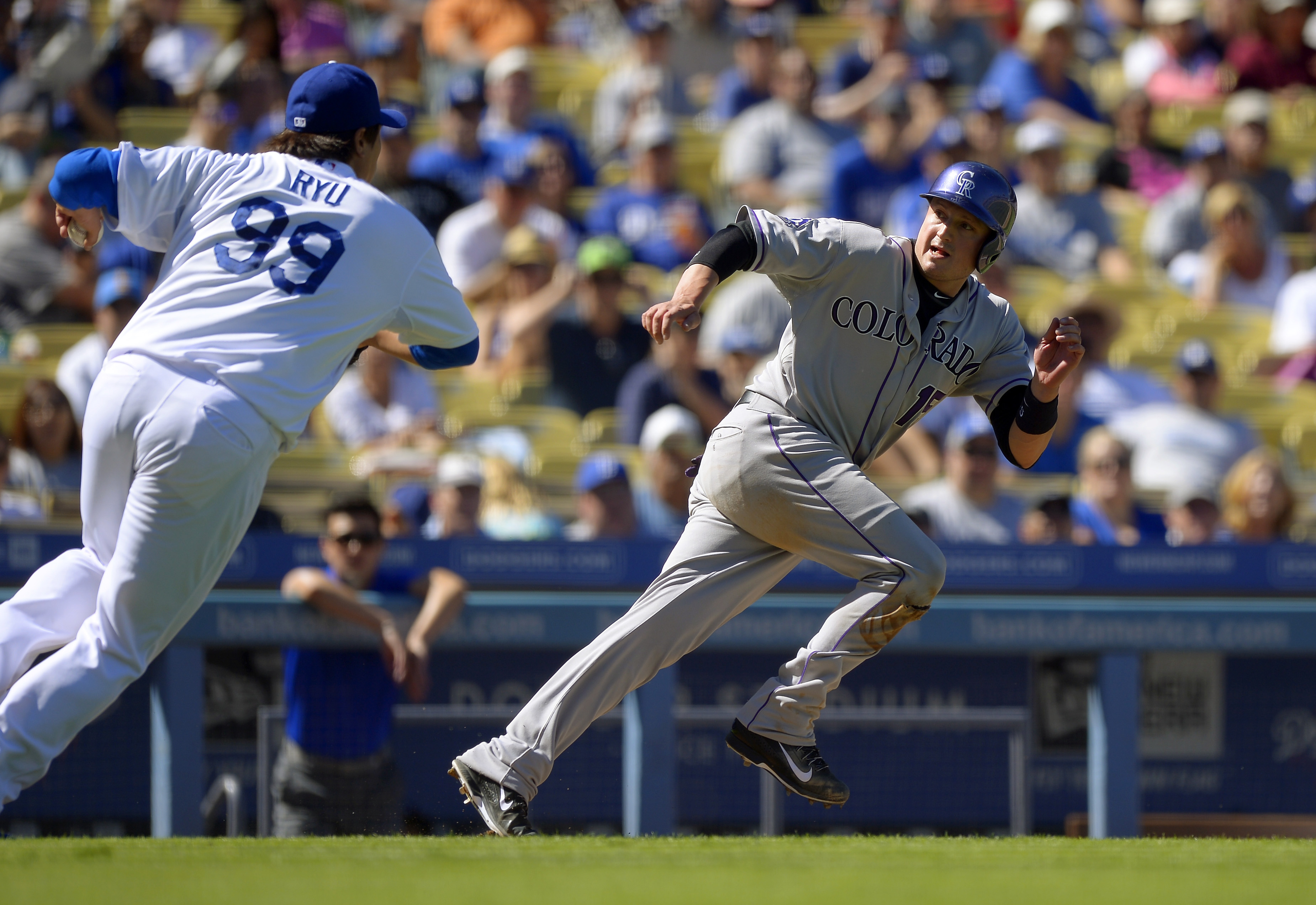 Los Angeles Dodgers starting pitcher Ryu Hyun-Jin, of South Korea, chases Colorado Rockies' Jordan Pacheco between third and home during a rundown in the fourth inning of a baseball game, Sunday, Sept. 29, 2013, in Los Angeles. Pacheco was tagged out on the play. (AP Photo/Mark J. Terrill)