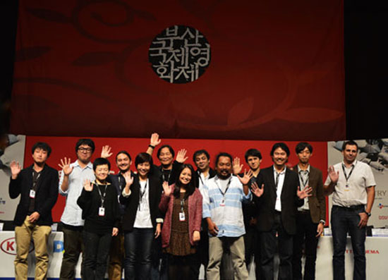 A group of Asian directors, whose works were featured in the “New Currents” section of the Busan International Film Festival, pose for the cameras at the
Centum City in Busan, Monday. / Korea Times photo by Yun Suh-young