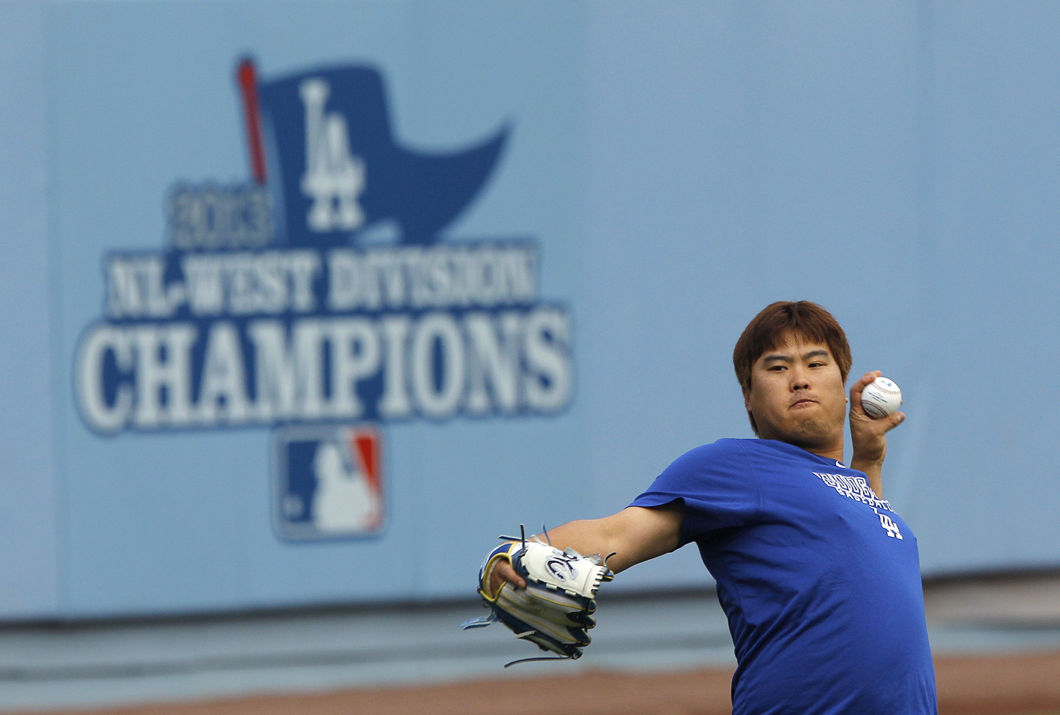 Los Angeles Dodgers starting pitcher Hyun-Jin Ryu, of South Korea, throws the ball during practice in preparation for Monday's Game 3 of the National League baseball championship series against the St. Louis Cardinals, on Sunday, Oct. 13, 2013, in Los Angeles. (AP Photo/Jae C. Hong)
