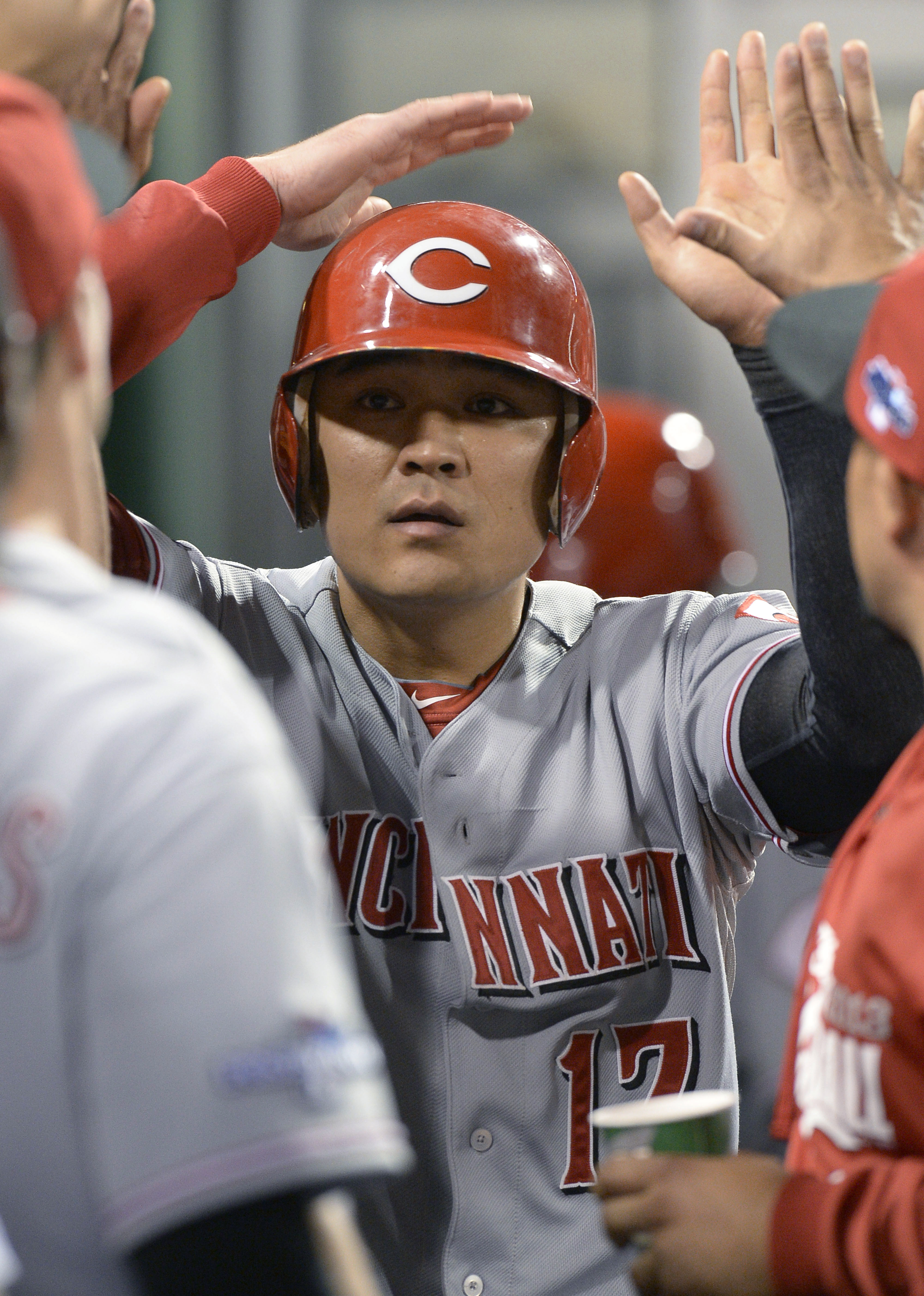 Cincinnati Reds' Shin-Soo Choo (17) is greeted by teammates in the dugout after scoring in the fourth inning of the NL wild-card playoff baseball game against the Pittsburgh Pirates on Tuesday, Oct. 1, 2013, in Pittsburgh. (AP Photo/Don Wright)