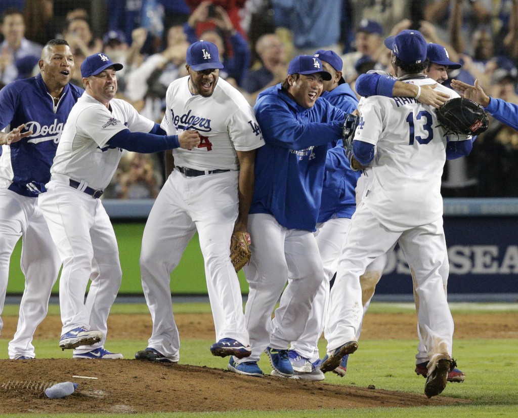 Los Angeles Dodgers pitcher Hyun-Jin Ryu,center right,  of South Korea, joins teammates in celebrating the Dodgers' 4-3 win over the Atlanta Braves in Game 4 of the National League baseball division series Monday, Oct. 7, 2013, in Los Angeles. The Dodgers advanced to the NL championship series. (AP Photo/Jae C. Hong)