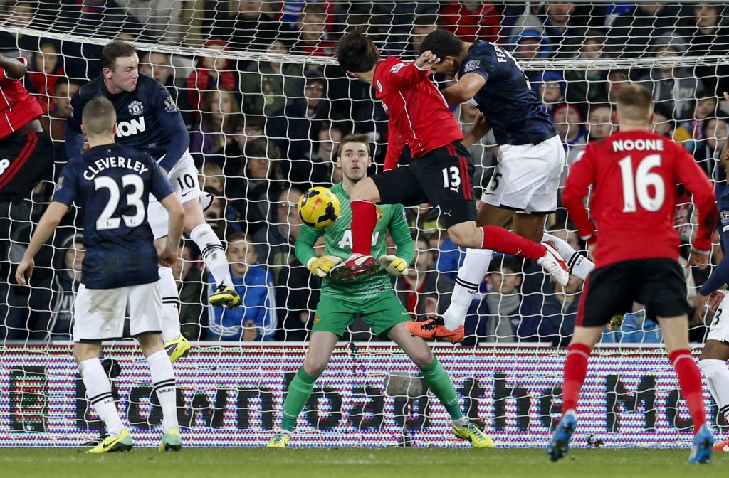 Cardiff City's Kim Bo-Kyung, center 13, scores his side's second goal to equalize the game 2-2 during the English Premier League soccer match between Manchester United and Cardiff City at Cardiff City Stadium in Cardiff, Wales, Sunday, Nov. 24, 2013. (AP Photo/Matt Dunham)