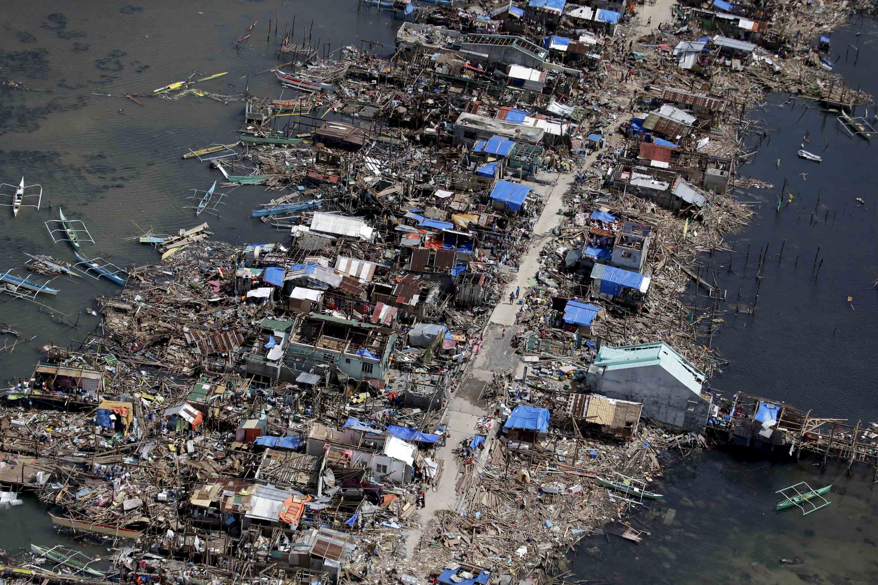 An aerial image taken from a Philippine Air Force helicopter shows the devastation of the first landfall by typhoon Haiyan in Guiuan, Eastern Samar province, central Philippines Monday, Nov. 11, 2013. Authorities said at least 2 million people in 41 provinces had been affected by Friday's typhoon Haiyan and at least 23,000 houses had been damaged or destroyed. (AP Photo/Bullit Marquez)