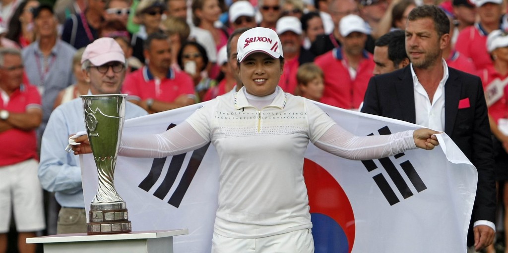 South Korea's Park In-bee holds the South Korean flag as she poses with the trophy after winning the Evian Masters women's golf tournament in Evian, France, Sunday, July 29, 2012.(AP Photo/Claude Paris)