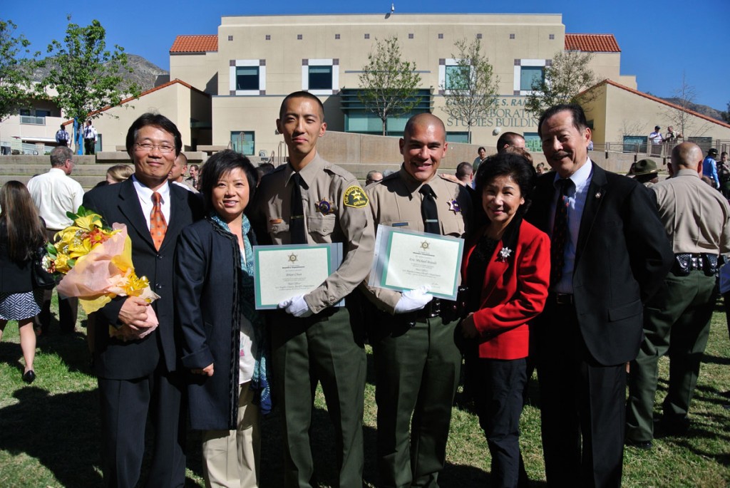 Brian Chun, middle left, and Eric Min, middle right posed for picture with their families.  