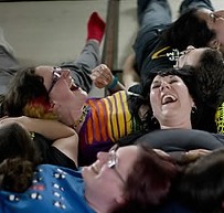 People laugh as they take part in performing a group exercise during a laughter yoga class in St. Albans, England on Sunday, June 9, 2013. (AP Photo/ yonhap)