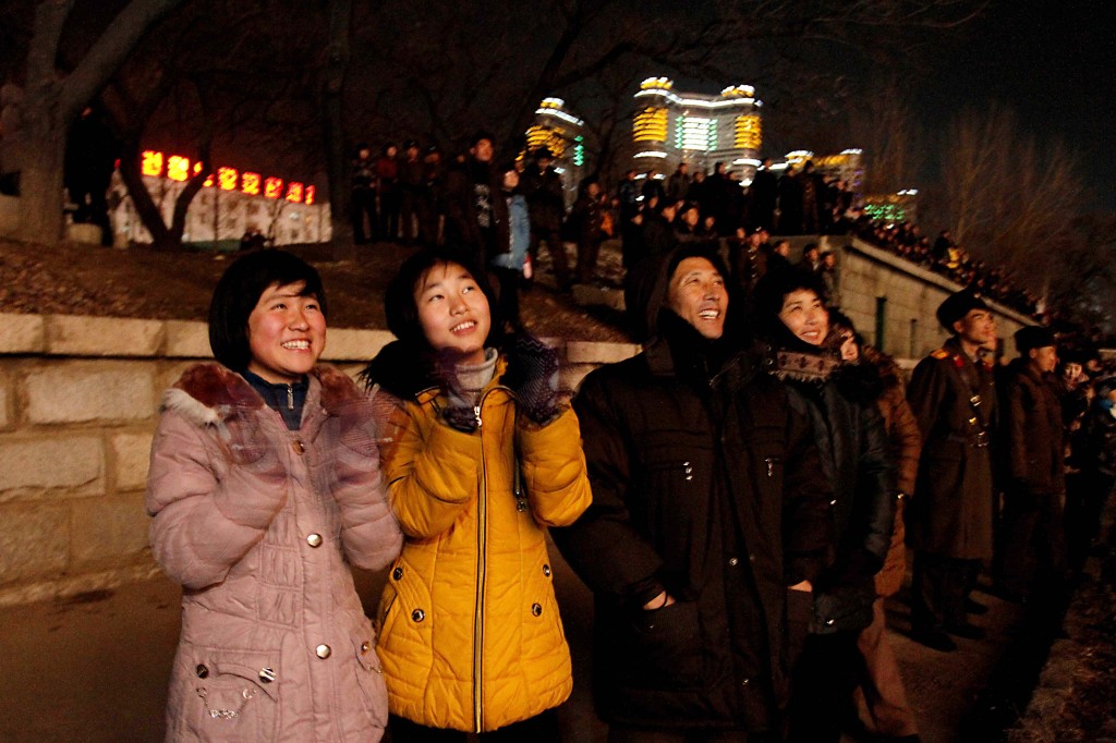 North Koreans gather along the banks of the Taedong River in Pyongyang, North Korea to watch a fireworks display to celebrate the New Year on Wednesday, Jan 1, 2014. (AP Photo/Kim Kwang Hyon)