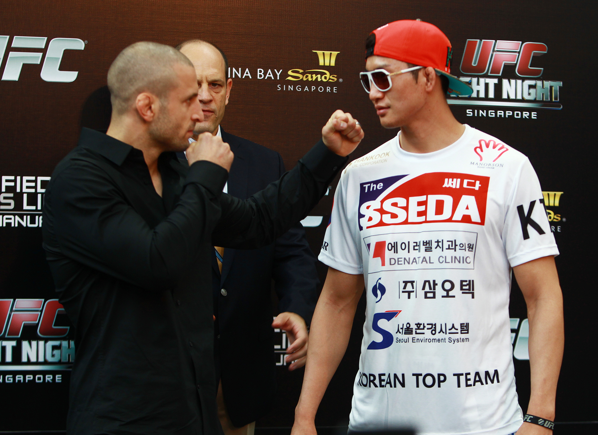 Lim, right, and Saffiedine posed for media on Friday. Lim could make race car drivers jealous. (UFC/Yonhap)