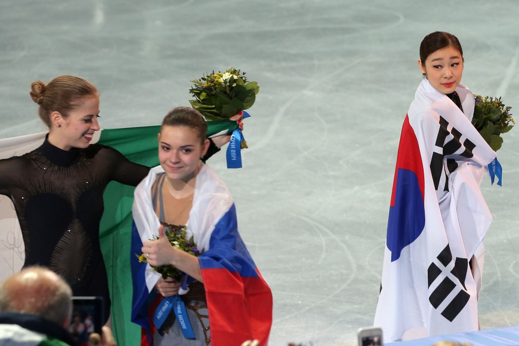 Kim Yuna, right, has a good reason for momentarily not looking as happy as the gold medalist Adelina Sotnikova of Russia, middle, and the bronze medalist Carolina Kostner of Italia. (Yonhap)  