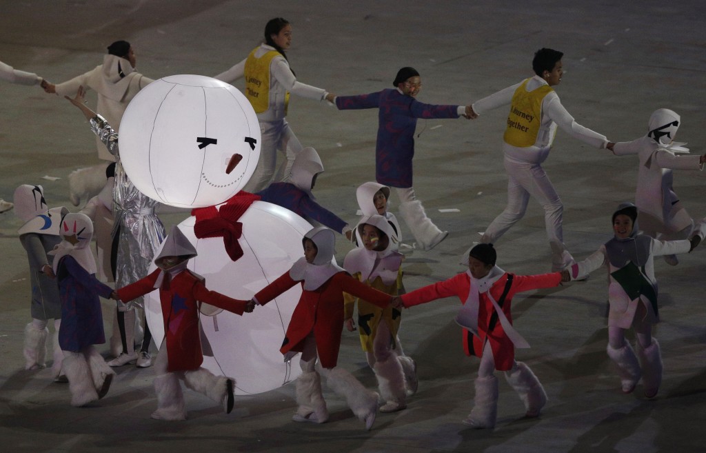South Korea artists dance around an illuminated snowman after the handing over of the next Winter Olympics to Pyeongchang, during the closing ceremony of the 2014 Winter Olympics, Sunday, Feb. 23, 2014, in Sochi, Russia. (AP Photo/Matthias Schrader)