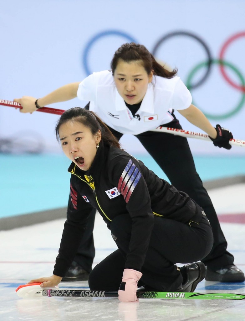 South Korea's skip Kim Jisun, front, yells during the women's curling competition against Japan at the 2014 Winter Olympics, Tuesday, Feb. 11, 2014, in Sochi, Russia