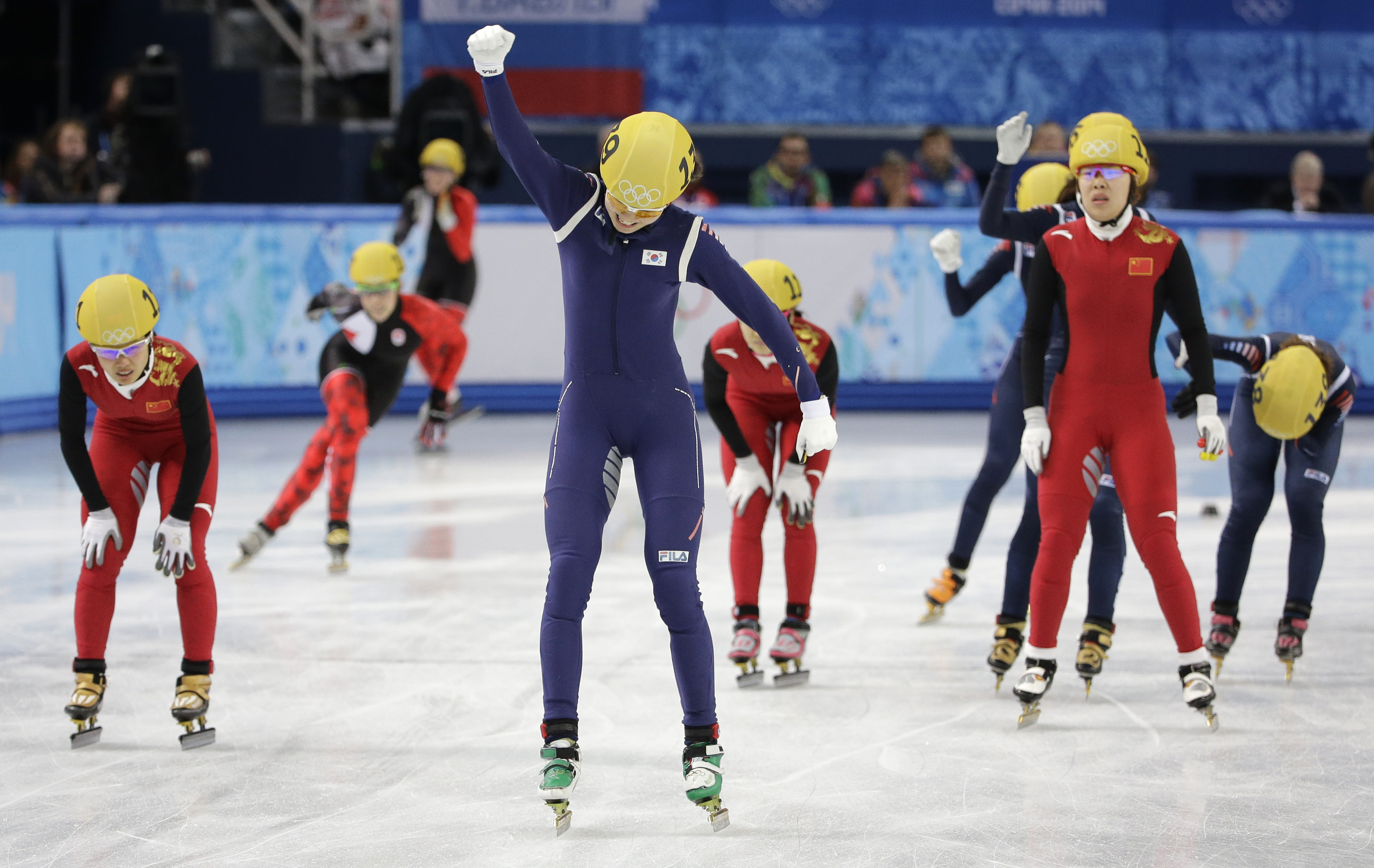 Shim Suk-Hee of South Korea, centre, celebrates her team's first place in the women's 3000m short track speedskating relay final at the Iceberg Skating Palace during the 2014 Winter Olympics, Tuesday, Feb. 18, 2014, in Sochi, Russia. (AP Photo/David J. Phillip )