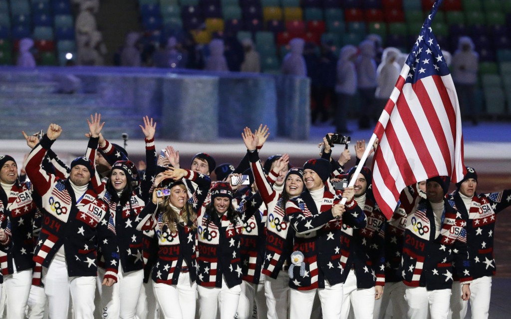 Todd Lodwick of the United States carries the national flag as he leads the team during the opening ceremony of the 2014 Winter Olympics in Sochi, Russia, Friday, Feb. 7, 2014. (AP Photo/Mark Humphrey)