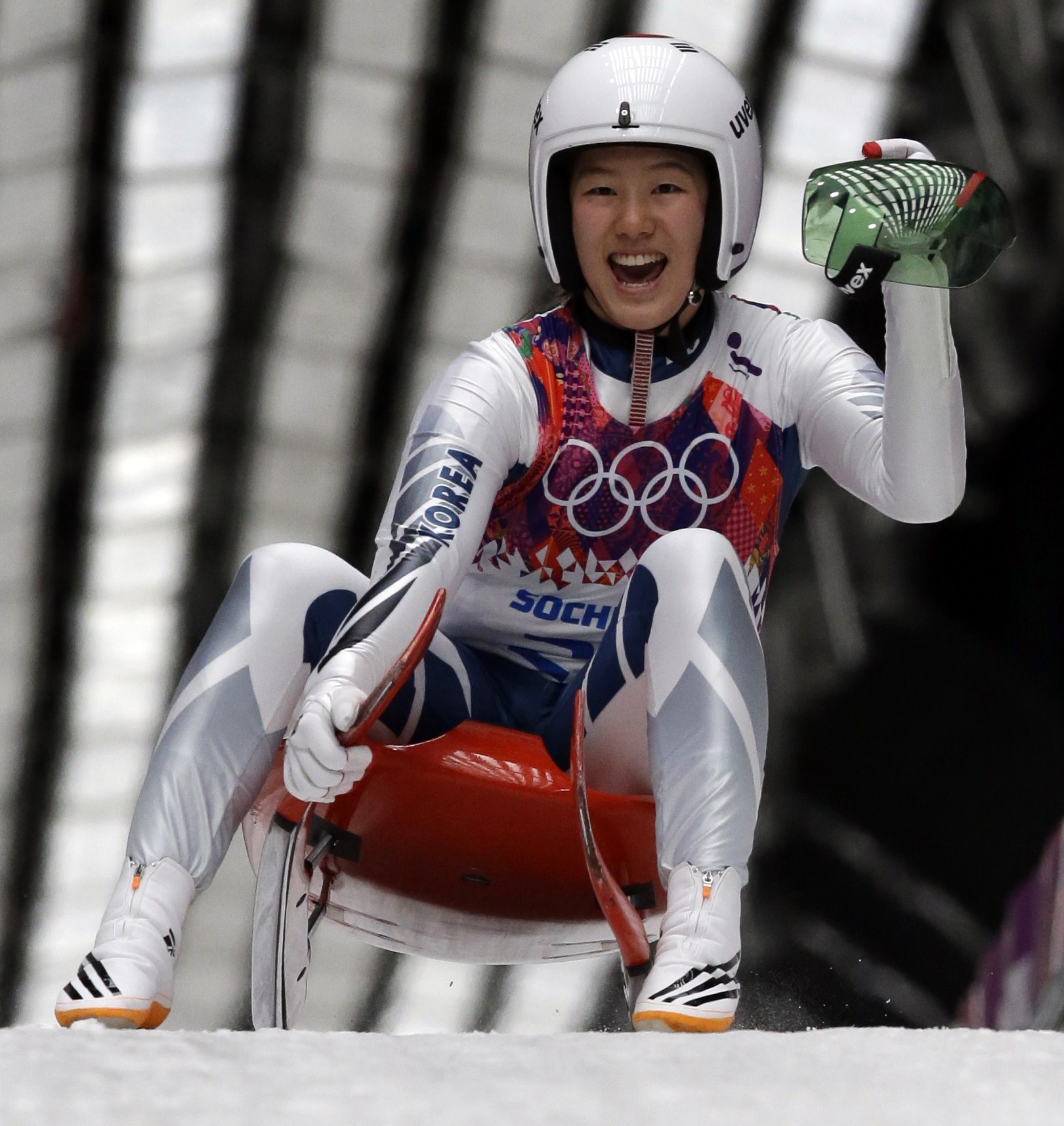 Sung Eunryung of S. Korea cheers after her final run during the women's singles luge competition at the 2014 Winter Olympics, Tuesday, Feb. 11, 2014, in Krasnaya Polyana, Russia. (AP Photo/Dita Alangkara)