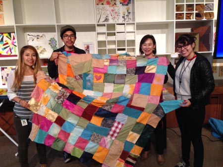 Korean-born textile artist Lee Young-min, second from right, shows a “bojagi” (wrapping cloth) along with her pupils at the Los Angeles County Museum of Art (LACMA). (Courtesy of Lee Young-min)