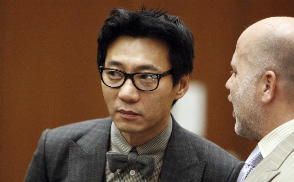 FILE-This Jan. 30, 2012 file photo shows Lee Young, one of the former founders of the Pinkberry yogurt chain stands with his attorney Philip Kent Cohen, right, during his arraignment in the Los Angeles Criminal Courts Building in Los Angeles. Lee has been convicted, Friday, Nov. 8, 2013,  of assault with a deadly weapon for striking a transient with a tire iron. Lee was sentenced Friday March 14, 2014, to seven years in prison for beating a homeless man with a tire iron in Los Angeles. (AP Photo/Los Angeles Times, Al Seib, Pool,File)