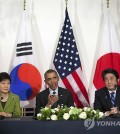 In this March 25, 2014 file photo, President Barack Obama meets with Japanese Prime Minister Shinzo Abe, right, and South Korean President Park Geun-hye at the U.S. Ambassador's Residence in the Hague, Netherlands. North Korea on Wednesday, March 26, 2014 (Yonhap)