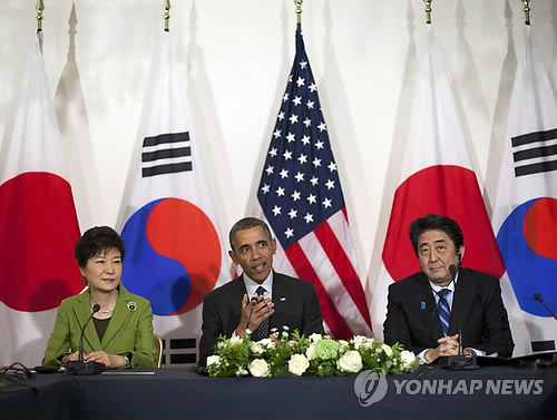 In this March 25, 2014 file photo, President Barack Obama meets with Japanese Prime Minister Shinzo Abe, right, and South Korean President Park Geun-hye at the U.S. Ambassador's Residence in the Hague, Netherlands. North Korea on Wednesday, March 26, 2014 (Yonhap)