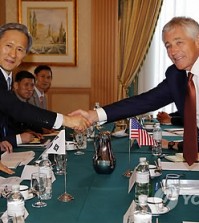 U.S. Defense Secretary Chuck Hagel, right, shakes hands with South Korea's Defense Minister Kim Kwan-jin during their bilateral meeting in Bandar Seri Begawan, Brunei, Wednesday, Aug. 28, 2013. (AP Photo/Vincent Thian/Yonhap)