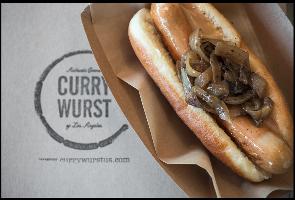 Doughnut hotdog is Kai Loebach’s creation: a wurst wrapped in specially made doughnut bread and topped with sauerkraut. (Currywurst Photo)