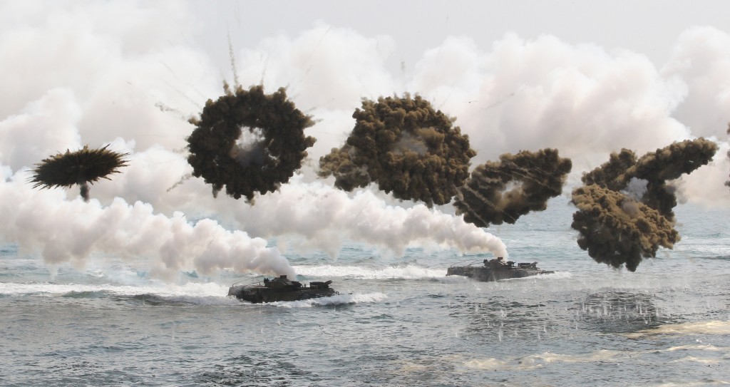 South Korean marine LVT-7 landing craft sail to shores through smoke screens during the U.S.-South Korea joint military exercises called Ssangyong,  part of the Foal Eagle military exercises, in Pohang, South Korea, Monday, March 31, 2014.  South Korea said North Korea has announced plans to conduct live-fire drills near the rivals' disputed western sea boundary. The planned drills Monday come after an increase in threatening rhetoric from Pyongyang and a series of rocket and ballistic missile launches in an apparent protest against the annual military exercises by Seoul and Washington.(AP Photo/Ahn Young-joon)