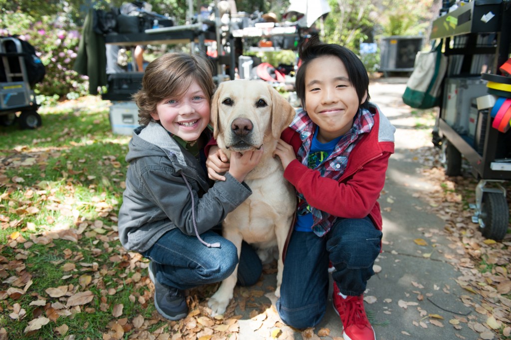 Lance Lim, right, and the show's main character, Eli Baker, poses with the guide dog they work with on Growing Up Fisher. (Courtesy of NBC)