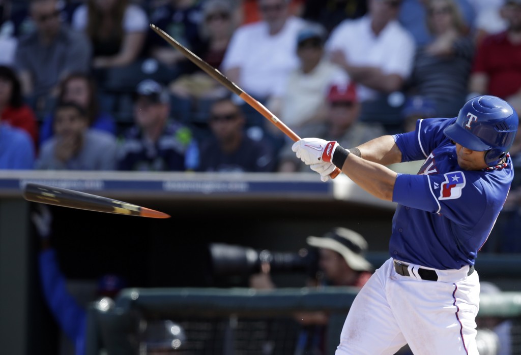 Texas Rangers' Shin-Soo Choo of South Korea breaks his bat on a ground out off a pitch from Cleveland Indians' Vinnie Pestano in the fifth inning of a spring training exhibition baseball game, Monday, March 3, 2014, in Surprise , Ariz. (AP Photo/Tony Gutierrez)