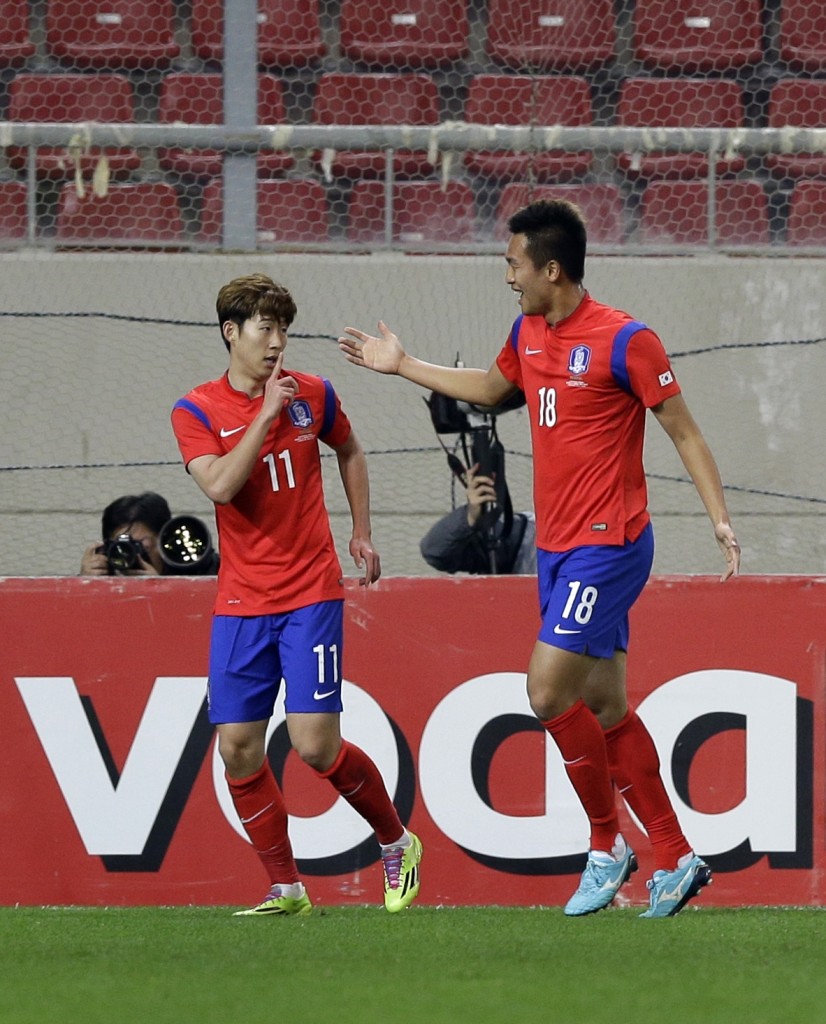 S.  Korea's Son Heungmin, left, celebrates after scoring the second goal of his team with teammate Kim Shinwook during a friendly match at Georgios Karaiskakis stadium against Greece in Piraeus port, near Athens, March 5, 2014. (AP Photo/Thanassis Stavrakis)