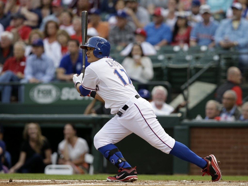 Texas Rangers' Shin-Soo Choo follows through on a single to center off Philadelphia Phillies' A.J. Burnett in the first inning of a baseball game, Tuesday, April 1, 2014, in Arlington, Texas. (AP Photo/Tony Gutierrez)