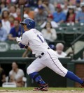 Texas Rangers' Shin-Soo Choo follows through on a single to center off Philadelphia Phillies' A.J. Burnett in the first inning of a baseball game, Tuesday, April 1, 2014, in Arlington, Texas. (AP Photo/Tony Gutierrez)