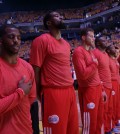 Los Angeles Clippers players listen to the national anthem wearing their warmup jerseys inside out to protest alleged racial remarks by team owner Donald Sterling before Game 4 of an opening-round NBA basketball playoff series against the Golden State Warriors on Sunday, April 27, 2014, in Oakland, Calif. (AP Photo/Marcio Jose Sanchez)