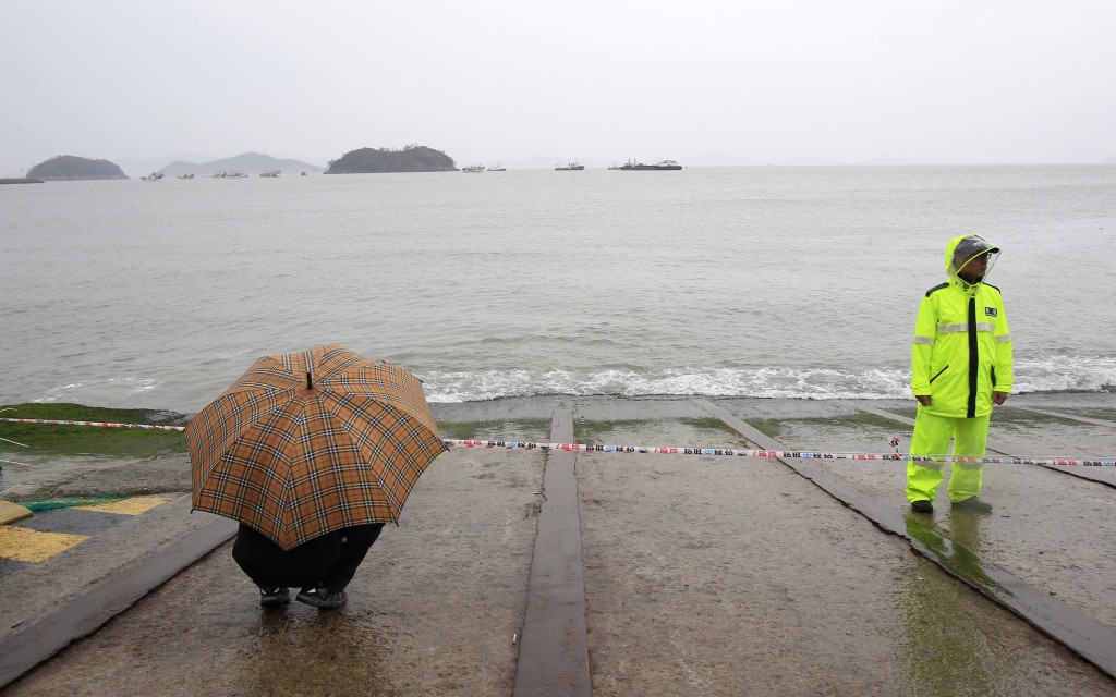 A relative of a passenger aboard the sunken Sewol ferry looks toward the sea as he awaits news on his missing loved one at a port in Jindo, South Korea, Sunday, April 27, 2014.  (AP Photo/Ahn Young-joon)