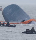 Rescue boats and ships from the Coast Guard approach the sunken ferry Sewol to search for passengers missing from the ship, Thursday. Rescue workers said the operation was hindered by bad weather conditions and high waves.  (Yonhap)