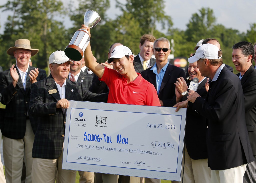 Noh Seung-yul, of South Korea, holds up his trophy with tournament officials after winning the Zurich Classic golf tournament at TPC Louisiana in Avondale, La., Sunday, April 27, 2014. (AP Photo/Bill Haber)
