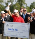 Noh Seung-yul, of South Korea, holds up his trophy with tournament officials after winning the Zurich Classic golf tournament at TPC Louisiana in Avondale, La., Sunday, April 27, 2014. (AP Photo/Bill Haber)