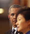 South Korean President Park Geun-hye, right, answers a report's question as U.S. President Barack Obama listens during a joint news conference following their meeting at the presidential Blue House in Seoul, Friday, April 25, 2014. (AP Photo/Kim Hong-Ji, Pool)