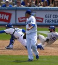 Colorado Rockies' Charlie Blackmon, right, scores after Brandon Barnes is caught stealing second as the ball goes past Los Angeles Dodgers catcher Tim Federowicz, left, while starting pitcher Ryu Hyun-Jin, of South Korea, looks on during the fifth inning of a baseball game, Sunday, April 27, 2014, in Los Angeles. (AP Photo/Mark J. Terrill)