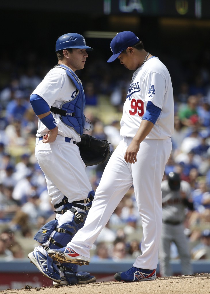 Los Angeles Dodgers starting pitcher Hyun-Jin Ryu, right, of South Korea, talks with catcher A.J. Ellis during the second inning of a baseball game against the San Francisco Giants on Friday, April 4, 2014, in Los Angeles. (AP Photo/Jae C. Hong)