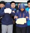 Crewmembers of the sunken ferry Sewol, including the chief engineer, two chief mates and a second mate, stand in front of reporters after being questioned during a judge’s review of prosecutors’ request for arrest warrants for abandoning passengers, at the Mokpo branch of the Gwangju District Court. (Yonhap)