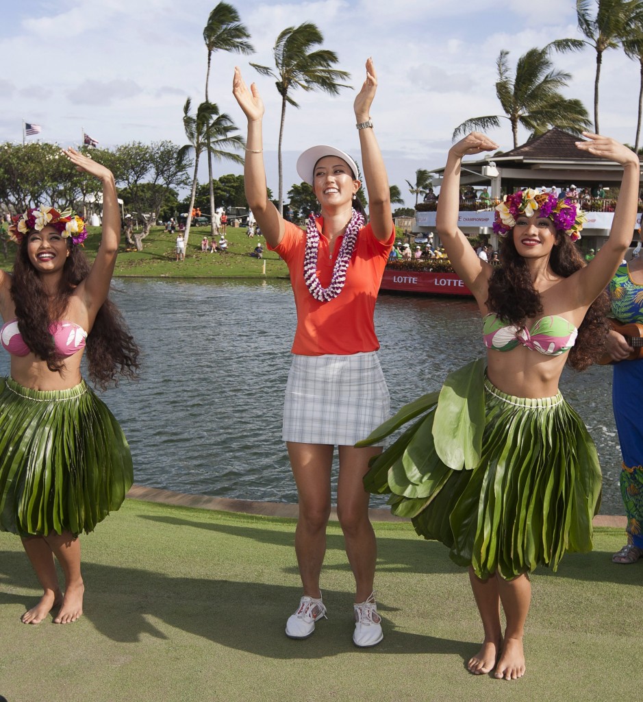 Michelle Wie, center, dances the hula after winning the 2014 LPGA LOTTE Championship golf tournament at Ko Olina Golf Club, Saturday, April 19, 2014, in Kapolei, Hawaii. (AP Photo/Eugene Tanner)