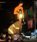 A firefighter administers CPR to one of the victims. (Yonhap)