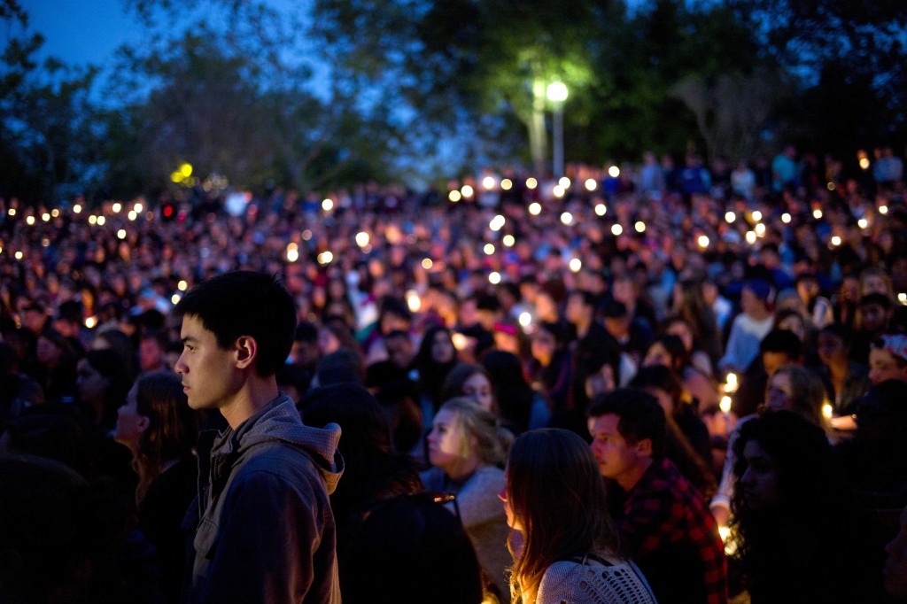 People gather at a park for a candlelight vigil to honor the victims of Friday night's mass shooting on Saturday, May 24, 2014, in Isla Vista, Calif. Sheriff's officials say Elliot Rodger, 22, went on a rampage near the University of California, Santa Barbara, stabbing three people to death at his apartment before shooting and killing three more in a crime spree through a nearby neighborhood. (AP Photo/Jae C. Hong)
