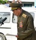 In this Saturday, May 17, 2014 photo, a North Korean official apologizes in front of families of victims of an accident at an apartment construction site and local residents in Pyongyang, North Korea. North Korean officials offered a rare public apology for the collapse of the apartment building under construction in Pyongyang, which a South Korean official said was believed to have caused considerable casualties that could mean hundreds might have died. (AP Photo/Kyodo News)