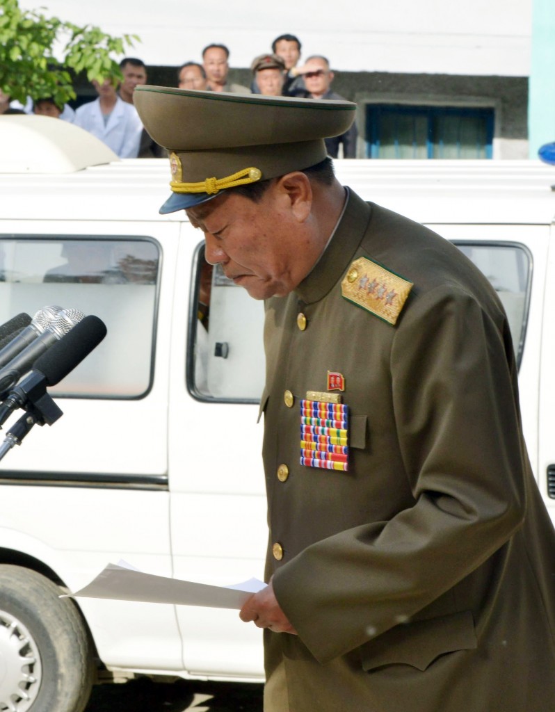 In this Saturday, May 17, 2014 photo, a North Korean official apologizes in front of families of victims of an accident at an apartment construction site and local residents in Pyongyang, North Korea. North Korean officials offered a rare public apology for the collapse of the apartment building under construction in Pyongyang, which a South Korean official said was believed to have caused considerable casualties that could mean hundreds might have died. (AP Photo/Kyodo News)