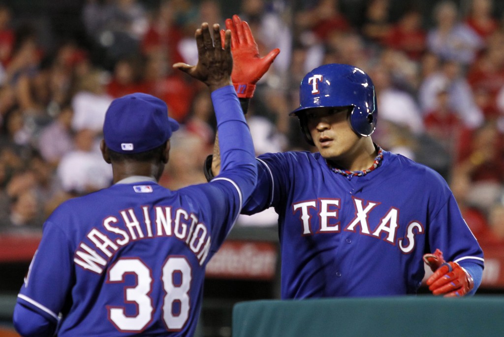 Texas Rangers manager Ron Washington (38) congratulates Shin-Soo Choo for hitting a solo home run against the Los Angeles Angels in the sixth inning of a baseball game on Friday, May 2, 2014, in Anaheim, Calif. (AP Photo/Alex Gallardo)