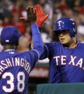 Texas Rangers manager Ron Washington (38) congratulates Shin-Soo Choo for hitting a solo home run against the Los Angeles Angels in the sixth inning of a baseball game on Friday, May 2, 2014, in Anaheim, Calif. (AP Photo/Alex Gallardo)