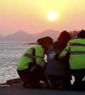 A relative, center, of a passenger aboard the sunken Sewol ferry is consoled by police officers as she awaits news on her missing loved one at a port in Jindo, South Korea, Wednesday, April 30, 2014.  (Yonhap)