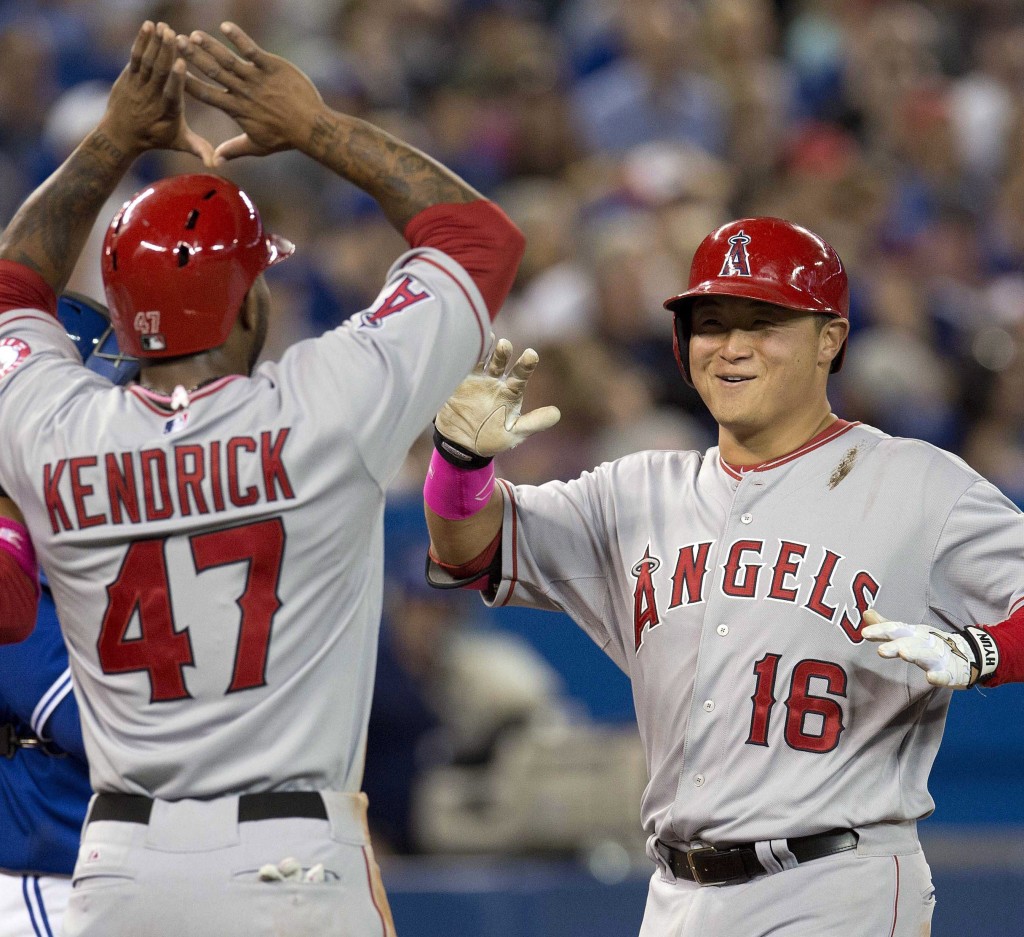 Los Angeles Angels' Hank Conger, right, is congratulated by Howie  Kendrick after hitting a three-run home run off Toronto Blue Jays pitcher Marcus Stroman during sixth-inning baseball game action in Toronto, Sunday, May 11, 2014. (AP Photo/The Canadian Press, Frank Gunn)