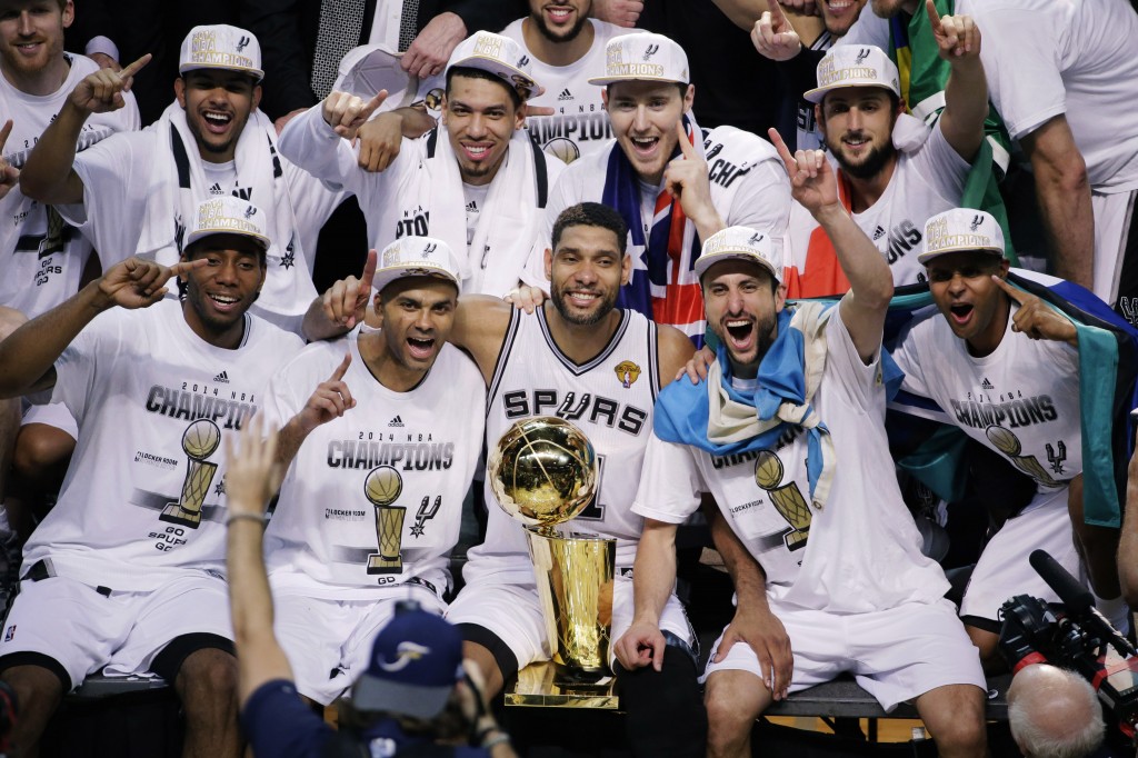 The San Antonio Spurs pose for a photo after Game 5 of the NBA basketball finals against the Miami Heat on Sunday, June 15, 2014, in San Antonio. The Spurs won the NBA championship 104-87. (AP Photo/Tony Gutierrez)