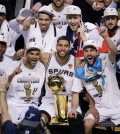 The San Antonio Spurs pose for a photo after Game 5 of the NBA basketball finals against the Miami Heat on Sunday, June 15, 2014, in San Antonio. The Spurs won the NBA championship 104-87. (AP Photo/Tony Gutierrez)